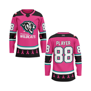 Pink hockey jersey with 'Woodstock Wildcats' logo and breast cancer awareness ribbons on a white background